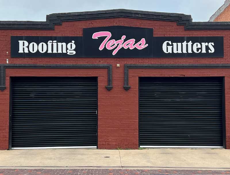 The entire Tejas Roofing & Gutters crew in front of their office building with 'Thank you for voting Tejas Roofing & Gutters Best of the Best Roofing Company & Gutter Company in Navarro County! We appreciate the continued support!' written at the bottom and the award logo on the top left